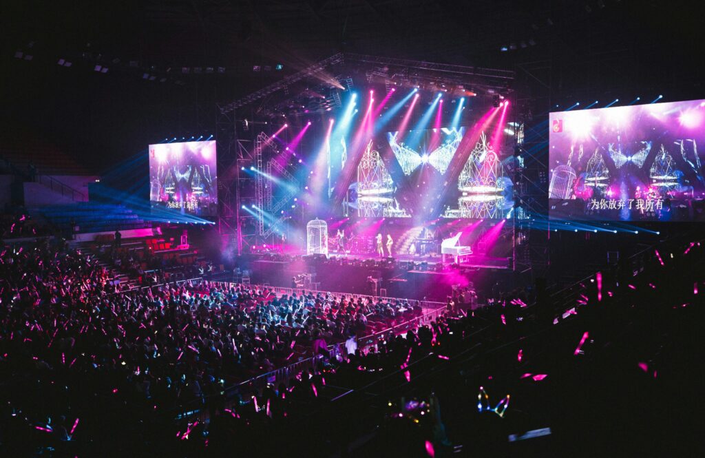 Colorful live concert with vibrant lighting, energetic crowd, and dynamic stage performance. conert makes celebration vibe freelance event photographer